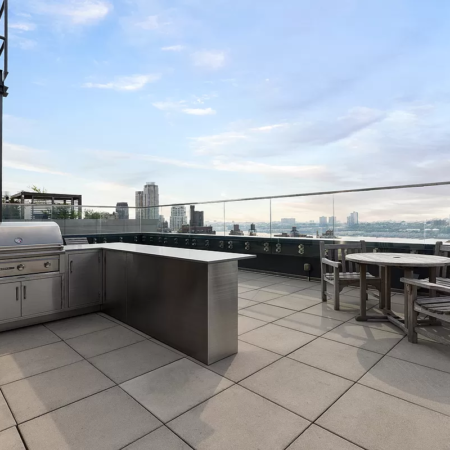 Rooftop Renovation, Manhattan Construction, Outdoor Kitchen Installation, Stone Paving, Glass Railings, Urban Landscaping, NYC Building Codes, Construction Permits, Modern Outdoor Spaces, Durable Pavers.